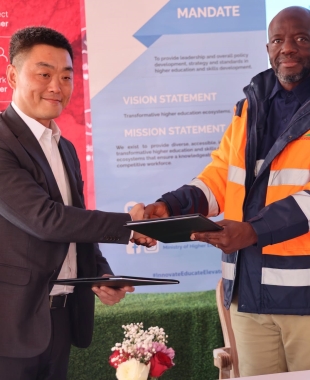 Permanent Secretary, Ministry of Higher Education Prof. Richard Tabulawa (R) and The acting President - Africa Operations and Director- Finance, MMG, Khoemacau, Mr Wei Gao (L) after signing the MOU.